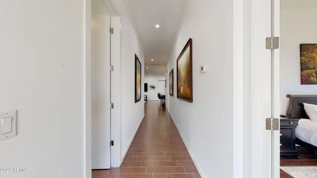 a view of a hallway with wooden floor and staircase