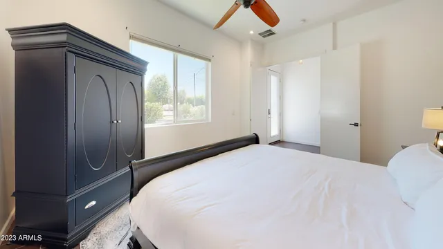 a bedroom with a bed and a window