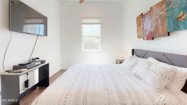 a bedroom with a bed and a flat screen tv