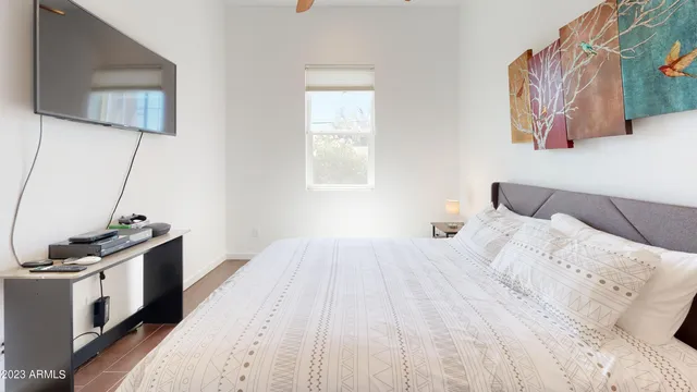 a bedroom with a bed and a flat screen tv