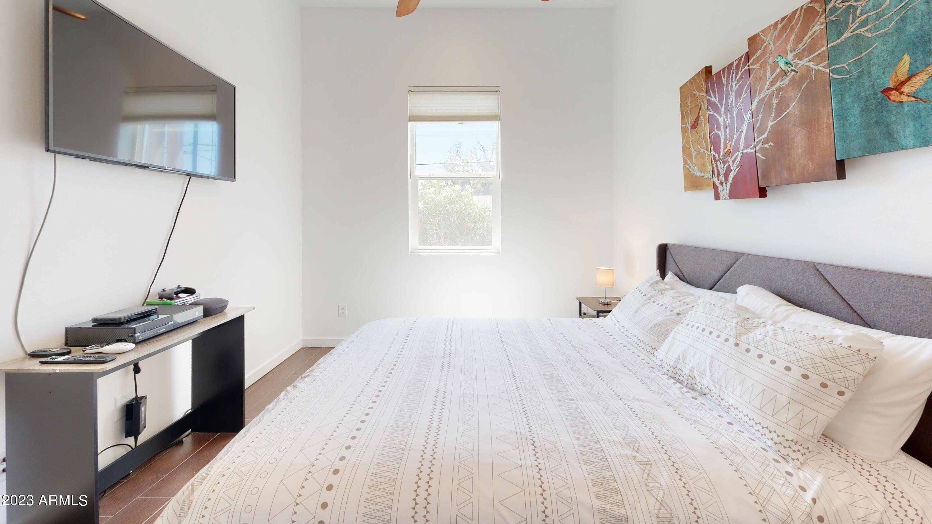 1202 East Colter Street Phoenix, AZ 85014 - Photo 20 of 30 a bedroom with a bed and a flat screen tv