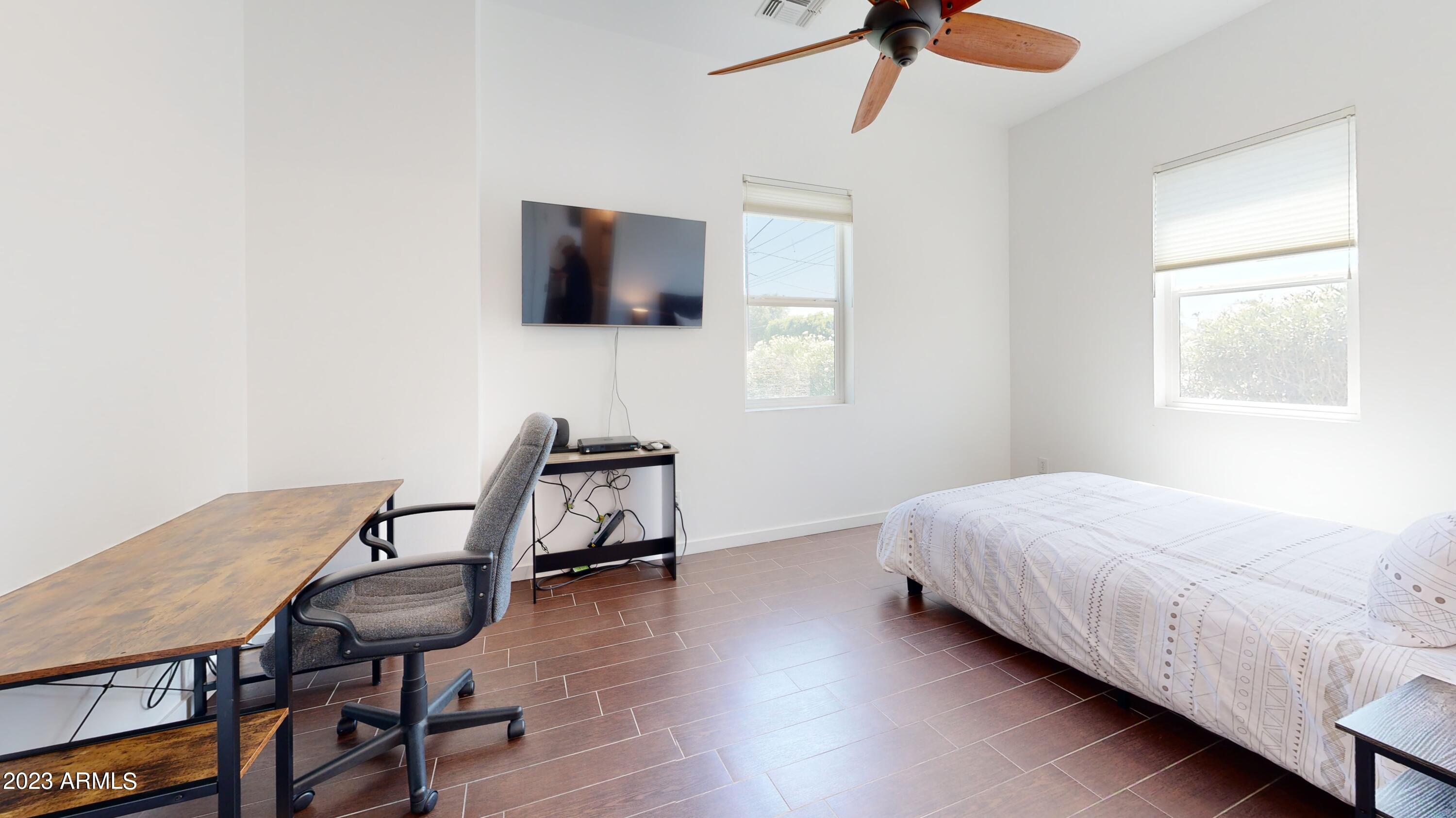 1202 East Colter Street Phoenix, AZ 85014 - Photo 21 of 30 a bedroom with a bed window and a flat screen tv