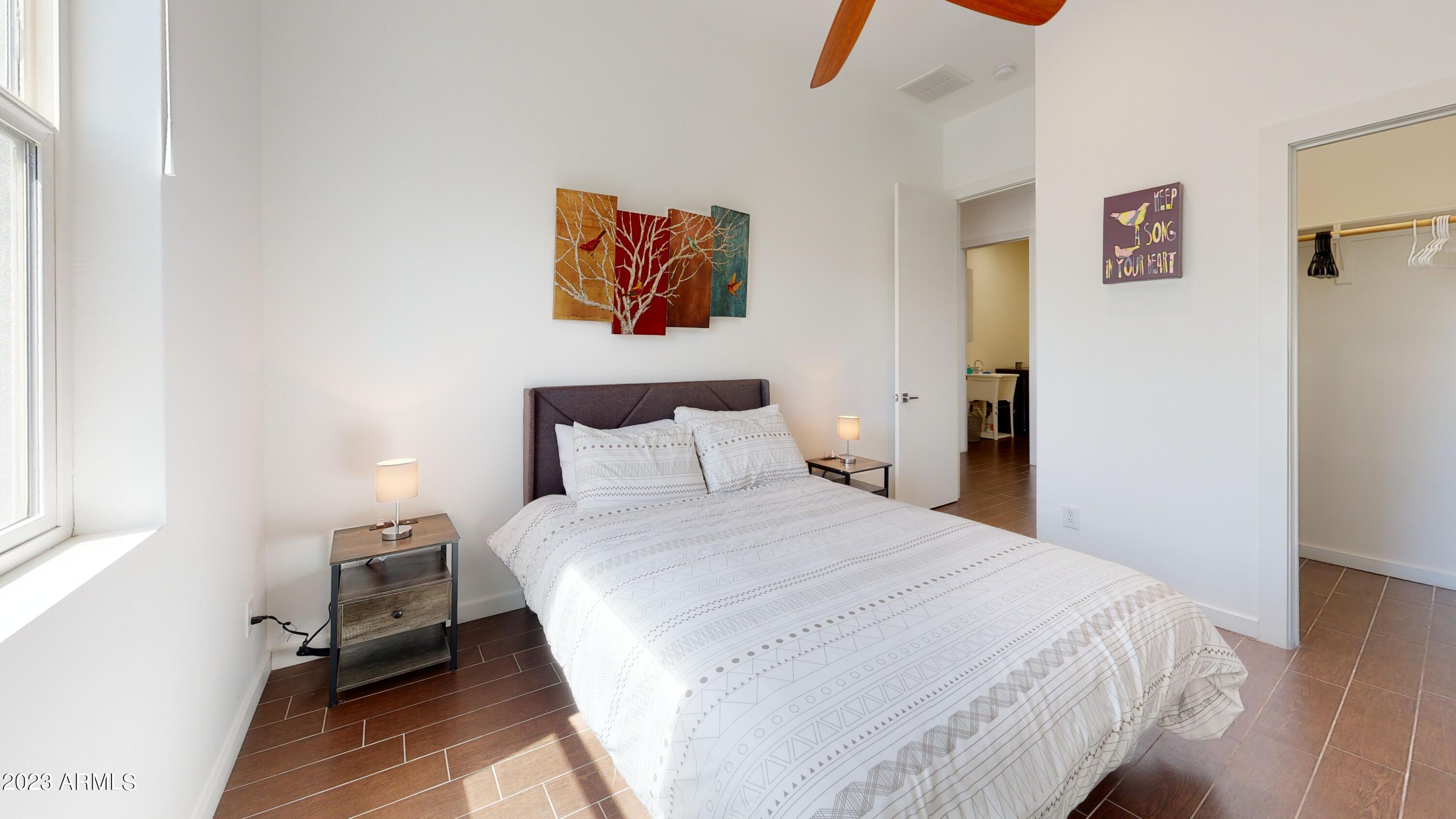 1202 East Colter Street Phoenix, AZ 85014 - Photo 23 of 30 a bedroom with a bed and a painting on the wall