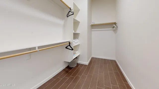 a view of a room with wooden floor and white walls