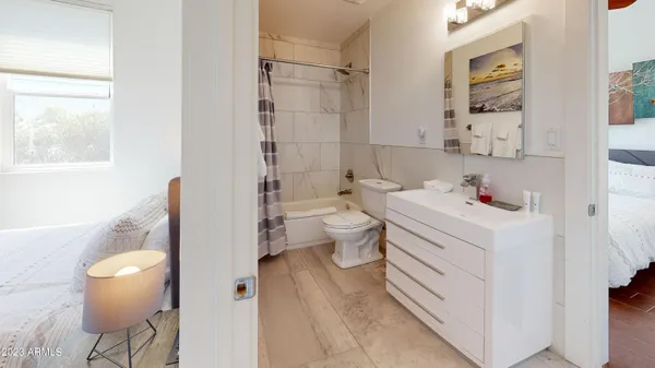 a bathroom with a sink toilet vanity and tub