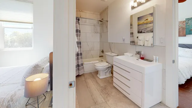 a bathroom with a sink toilet vanity and tub