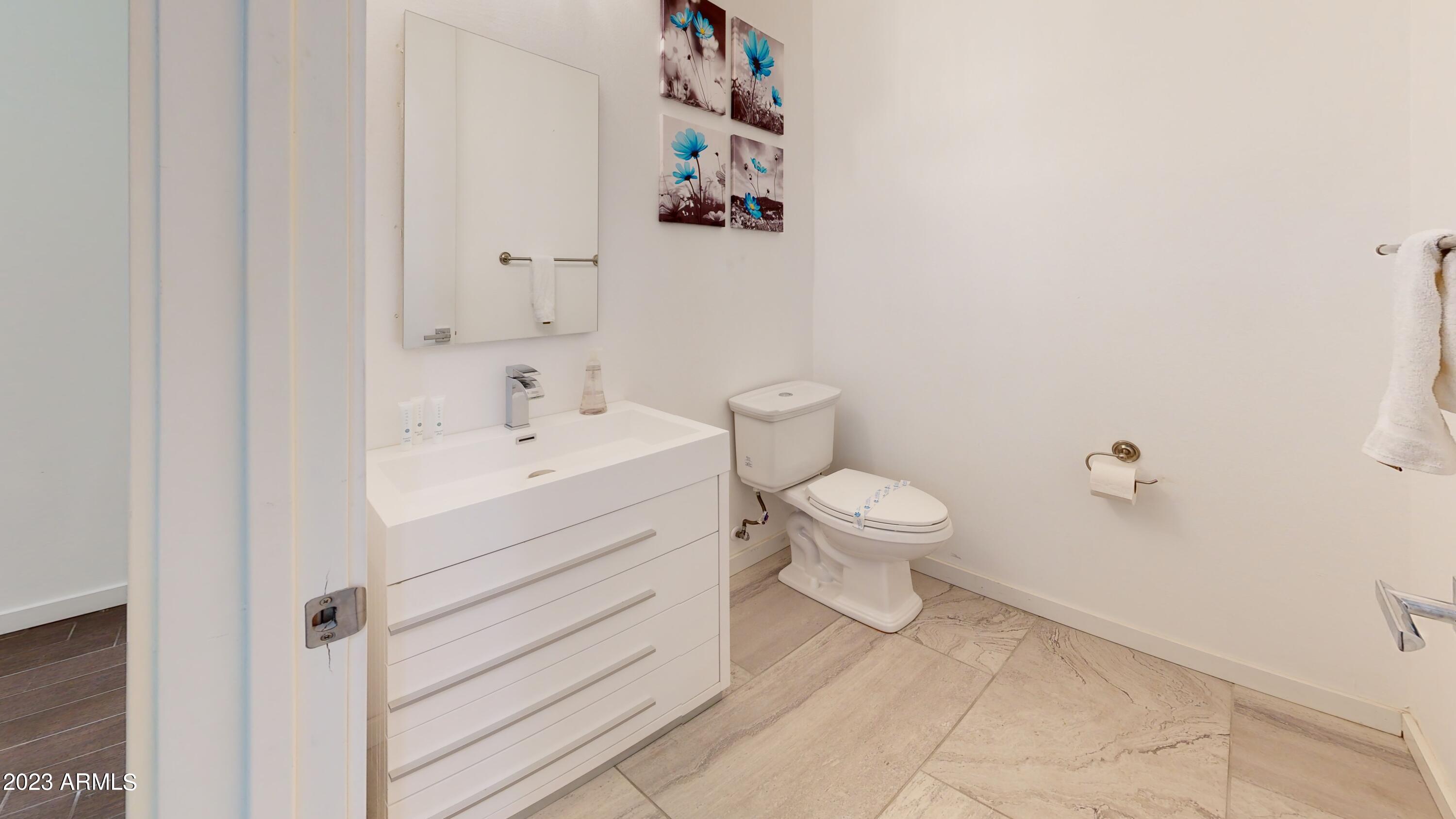 1202 East Colter Street Phoenix, AZ 85014 - Photo 27 of 30 a bathroom with a sink a toilet and a mirror