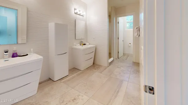 a bathroom with a sink a mirror and a shower