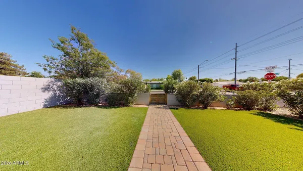 a view of a house with a backyard