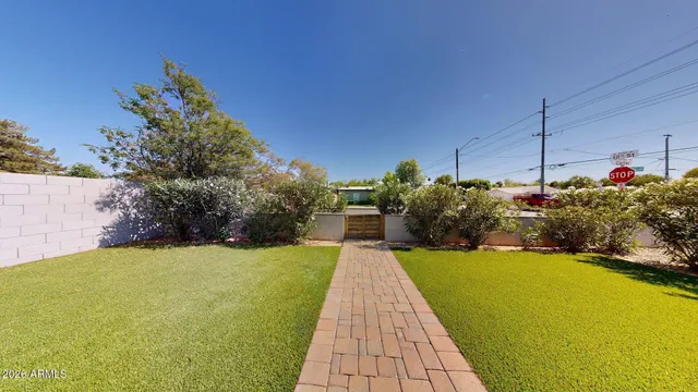 a view of a house with a backyard