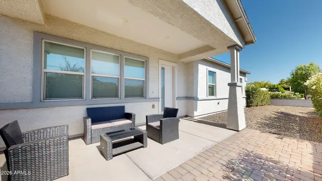 a bedroom with furniture and a large window