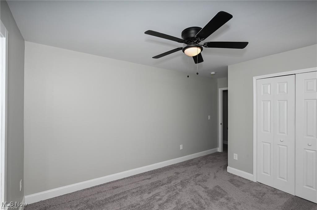 7613 Jefferson Road Ashtabula, OH 44004 - Photo 28 of 35 Unfurnished bedroom featuring ceiling fan, a closet, and light colored carpet