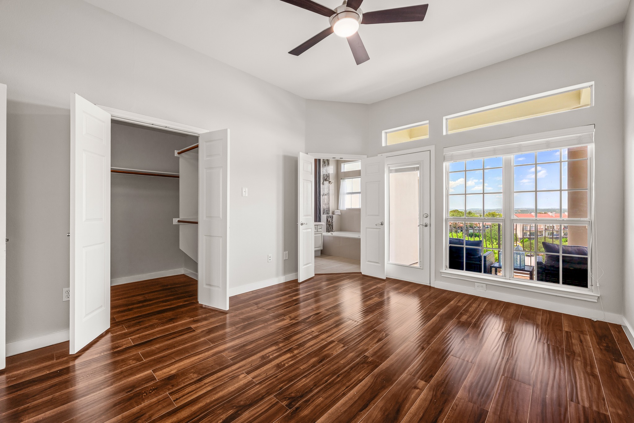 2918 Ranch Road 620 North, Unit S242 Austin, TX 78734 - Photo 22 of 35 Rich hardwood floors lead to a balcony with neighborhood views, offering a private retreat.
