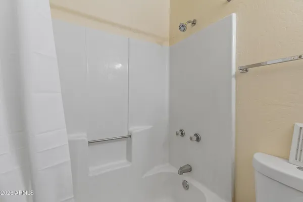 a bathroom with a granite countertop sink toilet a mirror and shower