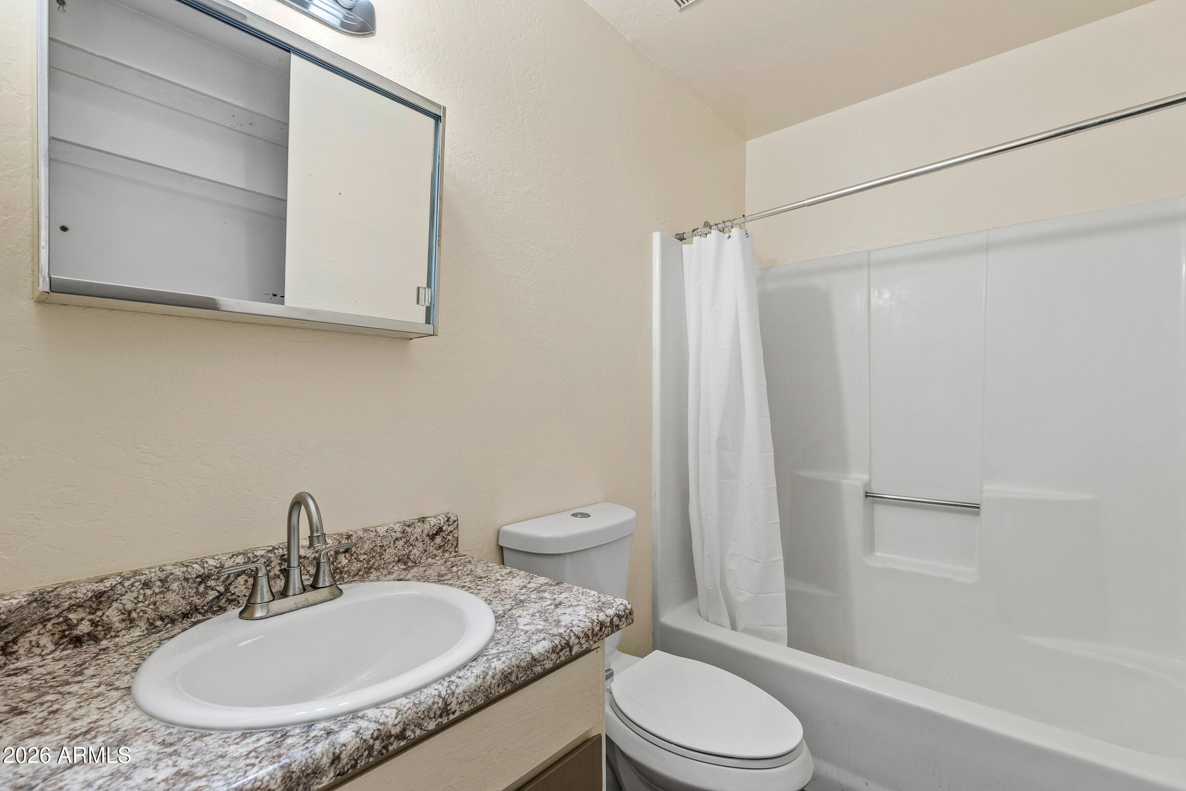 108 East Paseo Del Rio Flagstaff, AZ 86001 - Photo 23 of 25 a bathroom with a granite countertop sink toilet a mirror and shower