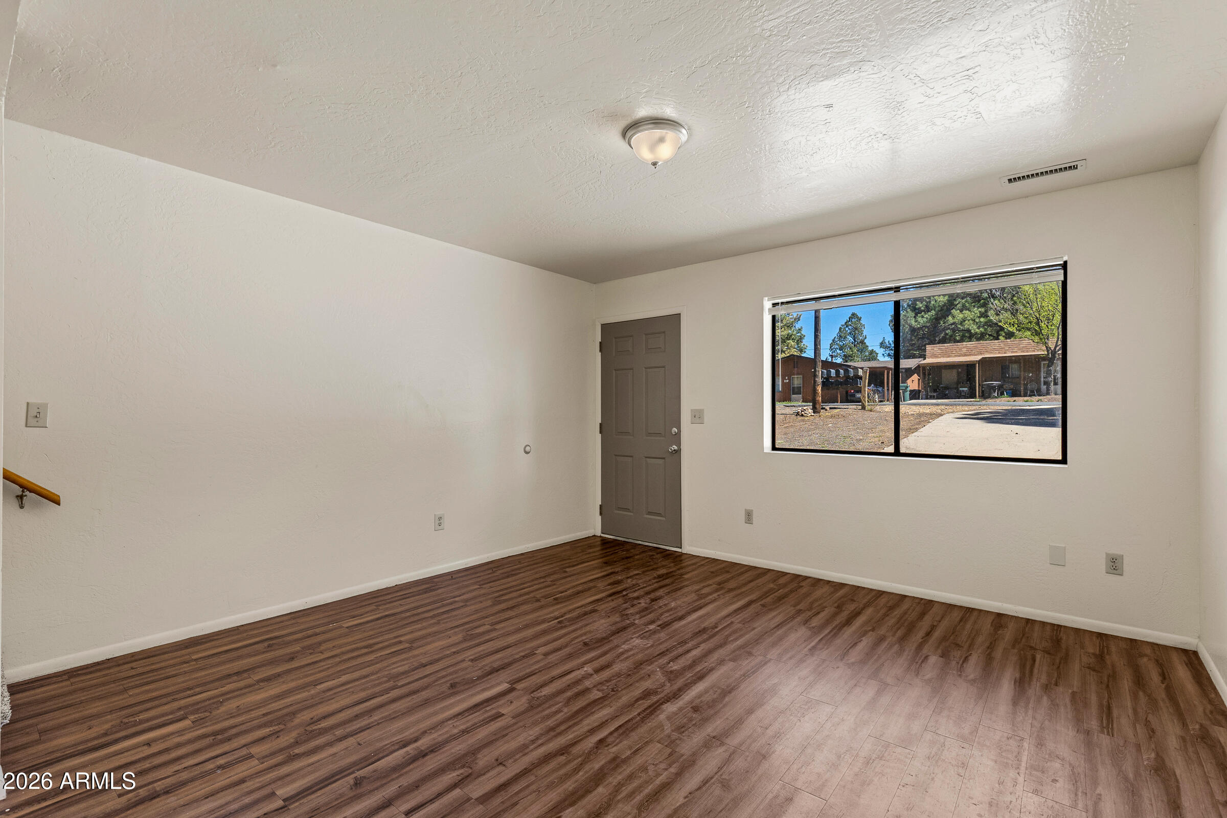 108 East Paseo Del Rio Flagstaff, AZ 86001 - Photo 8 of 25 an empty room with wooden floor and windows