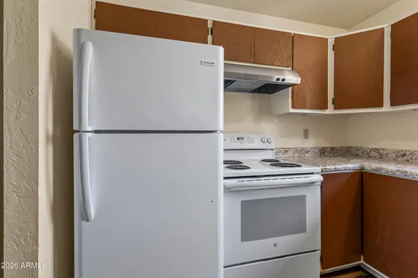 a white refrigerator freezer sitting inside of a kitchen
