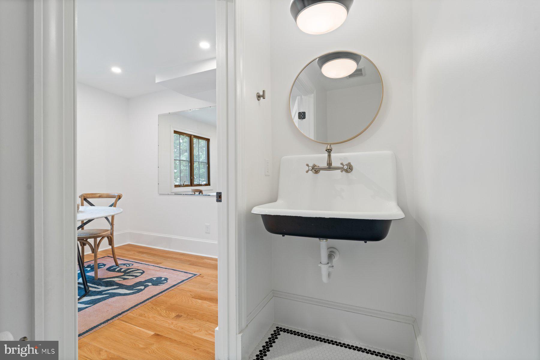 7113 Bristol Road Baltimore, MD 21212 - Photo 13 of 31 a bathroom with a sink and a mirror