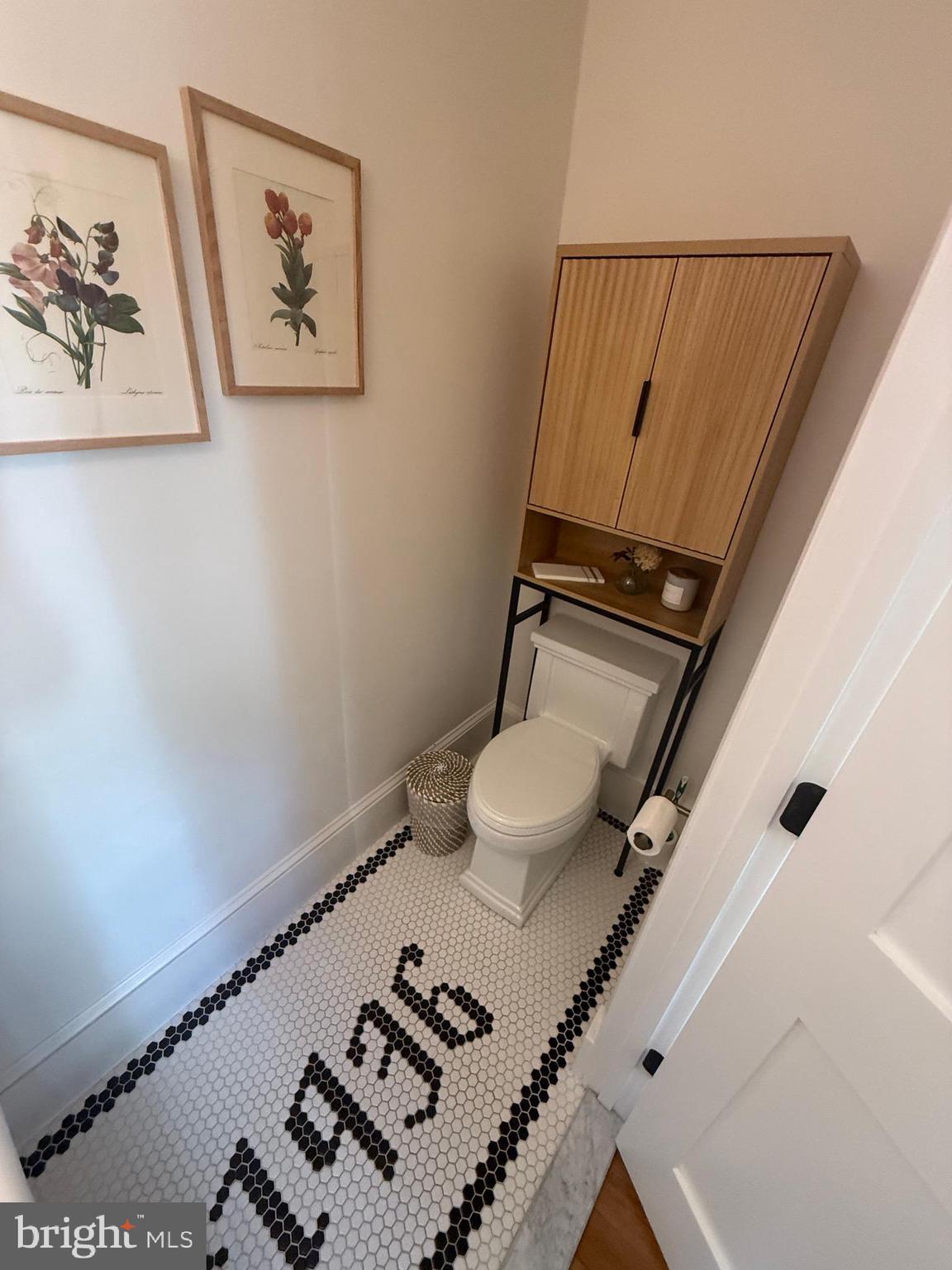 7113 Bristol Road Baltimore, MD 21212 - Photo 14 of 31 a bathroom with a toilet and a shower curtain