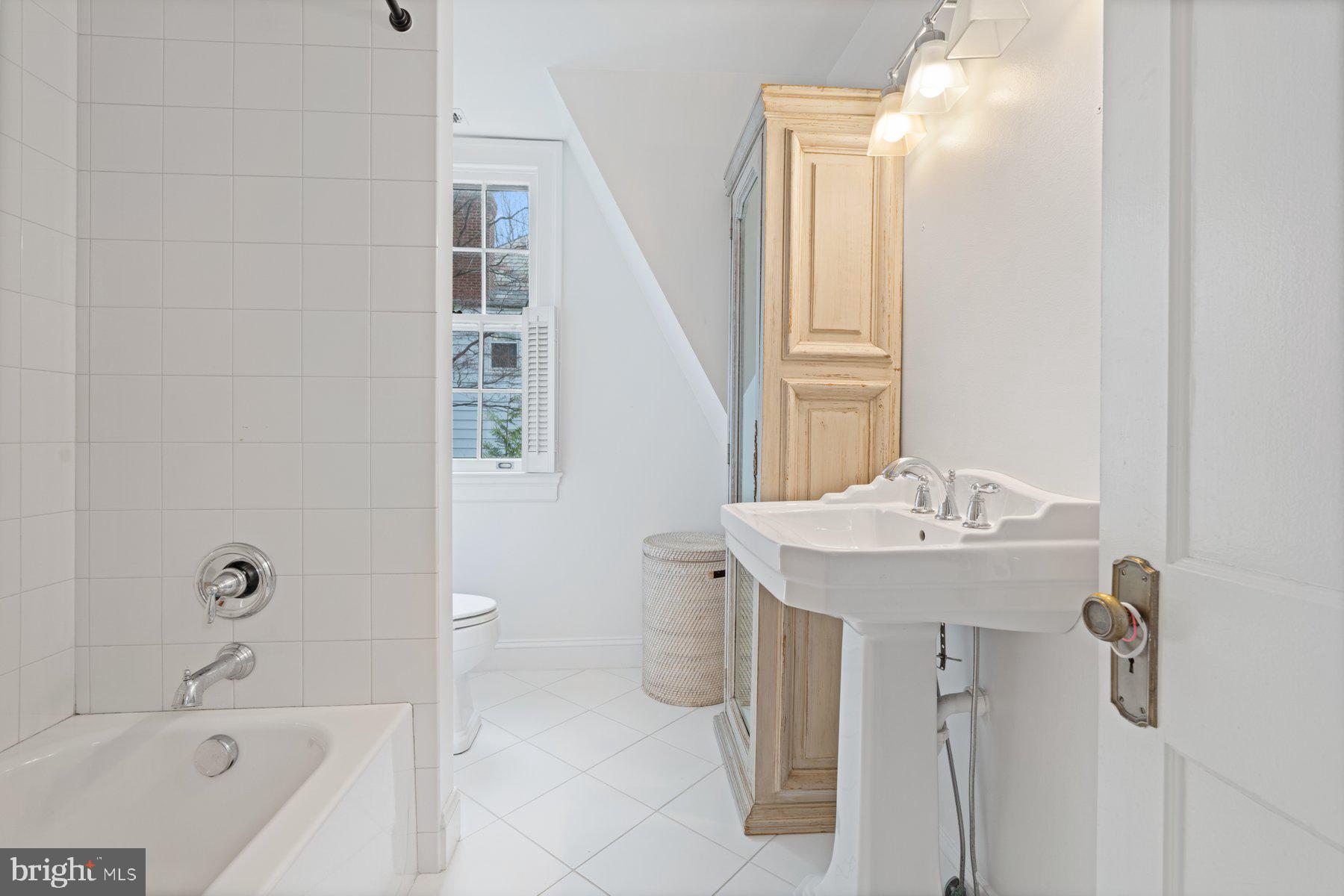 7113 Bristol Road Baltimore, MD 21212 - Photo 17 of 31 a bathroom with a sink a toilet and shower