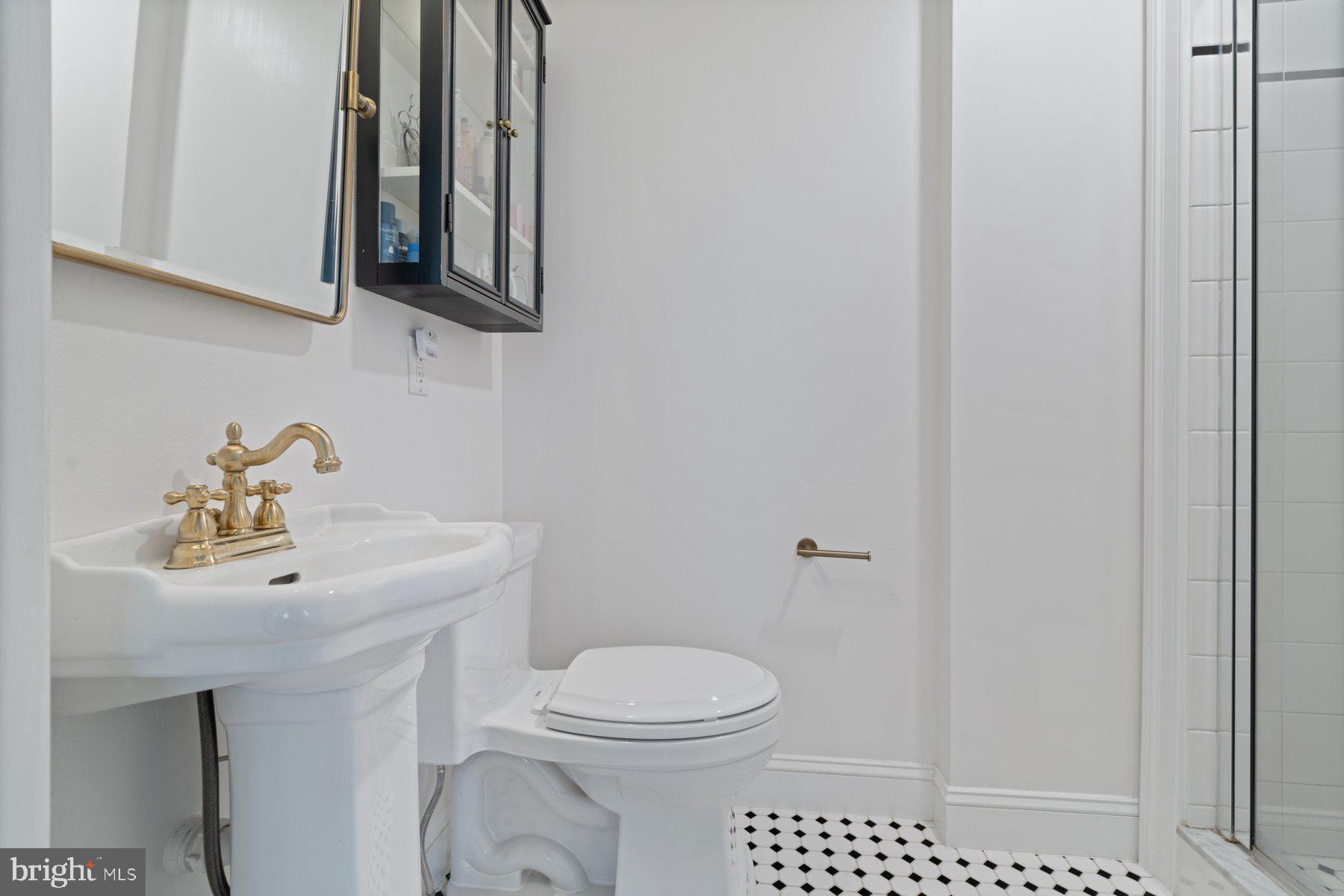 7113 Bristol Road Baltimore, MD 21212 - Photo 21 of 31 a bathroom with a sink a toilet and mirror