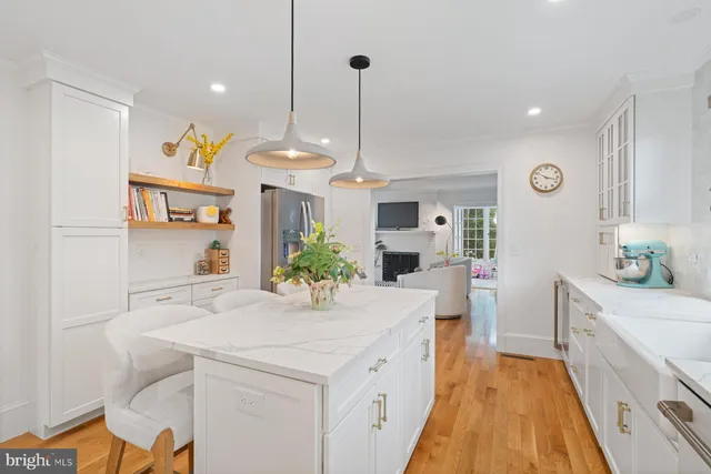 a view of a kitchen area with furniture and wooden floor