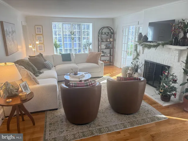 a living room with furniture a fireplace and a window