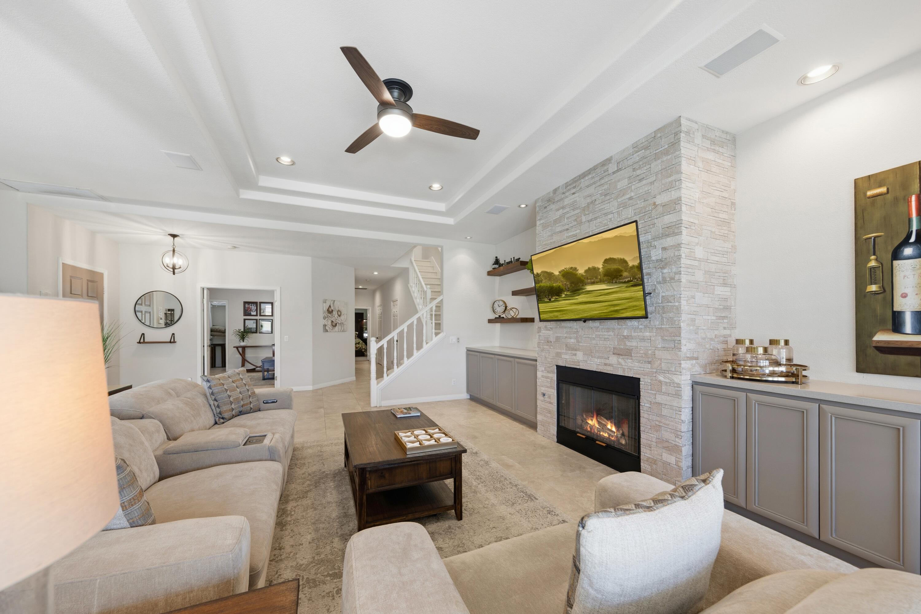 39 Augusta Drive Rancho Mirage, CA 92270 - Photo 13 of 53 a living room with furniture a fireplace and a flat screen tv
