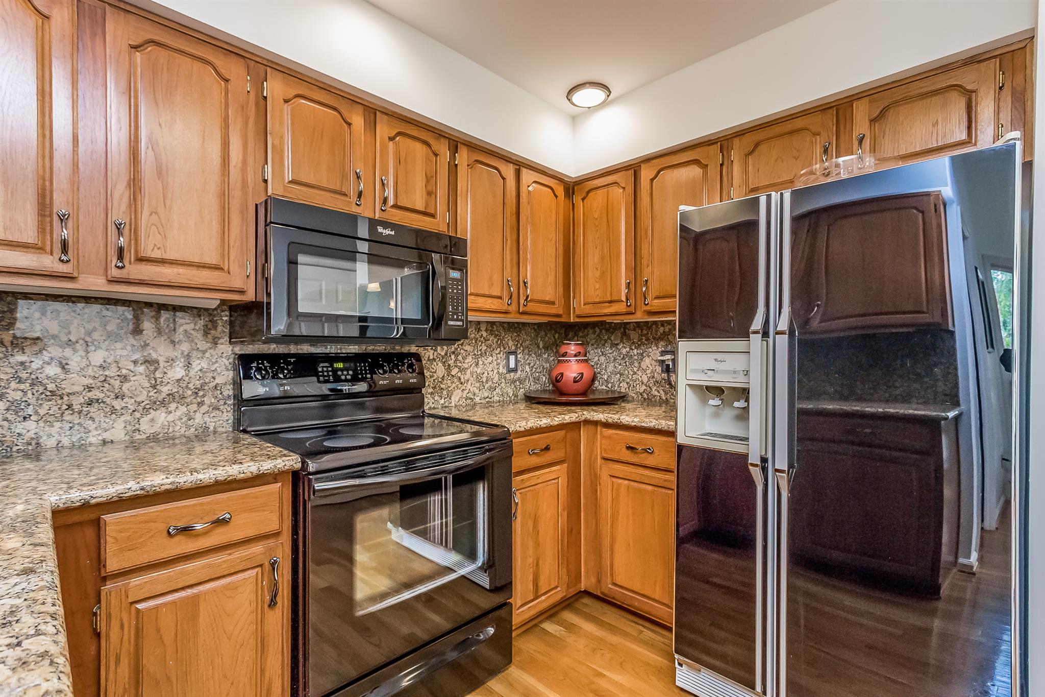 5253 Rustic Way Old Hickory, TN 37138 - Photo 10 of 27 a kitchen with granite countertop a refrigerator stove and microwave