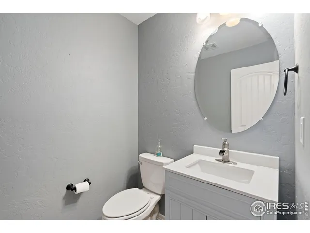 a bathroom with a sink mirror and toilet