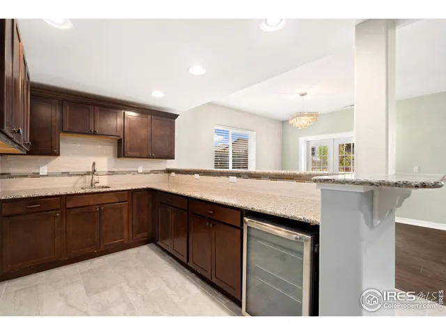a kitchen with granite countertop a sink and cabinets