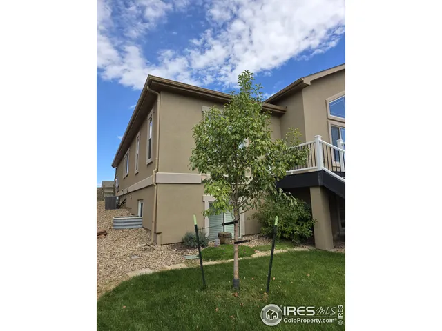 a backyard of a house with table and chairs