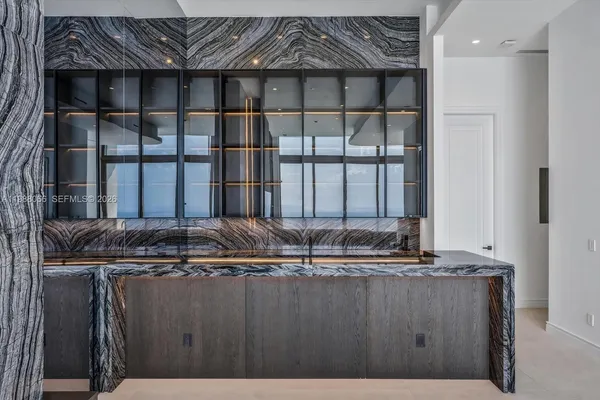a kitchen with stainless steel appliances granite countertop a sink and a refrigerator