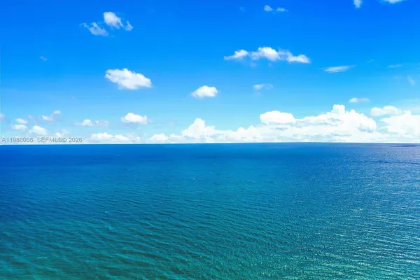 an empty room with wooden floor and a cabinet