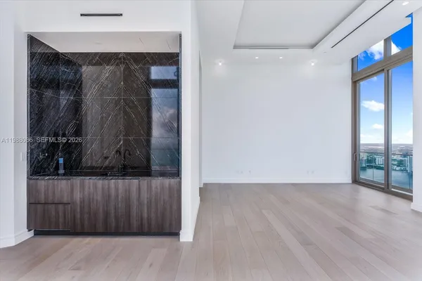 a view of a room with lamp and wooden floor