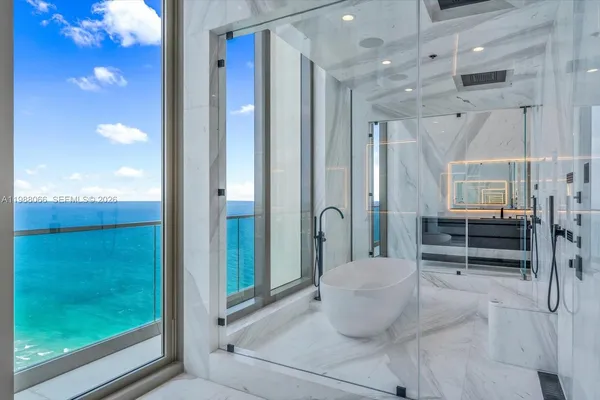 a bathroom with a granite countertop sink a toilet and mirror