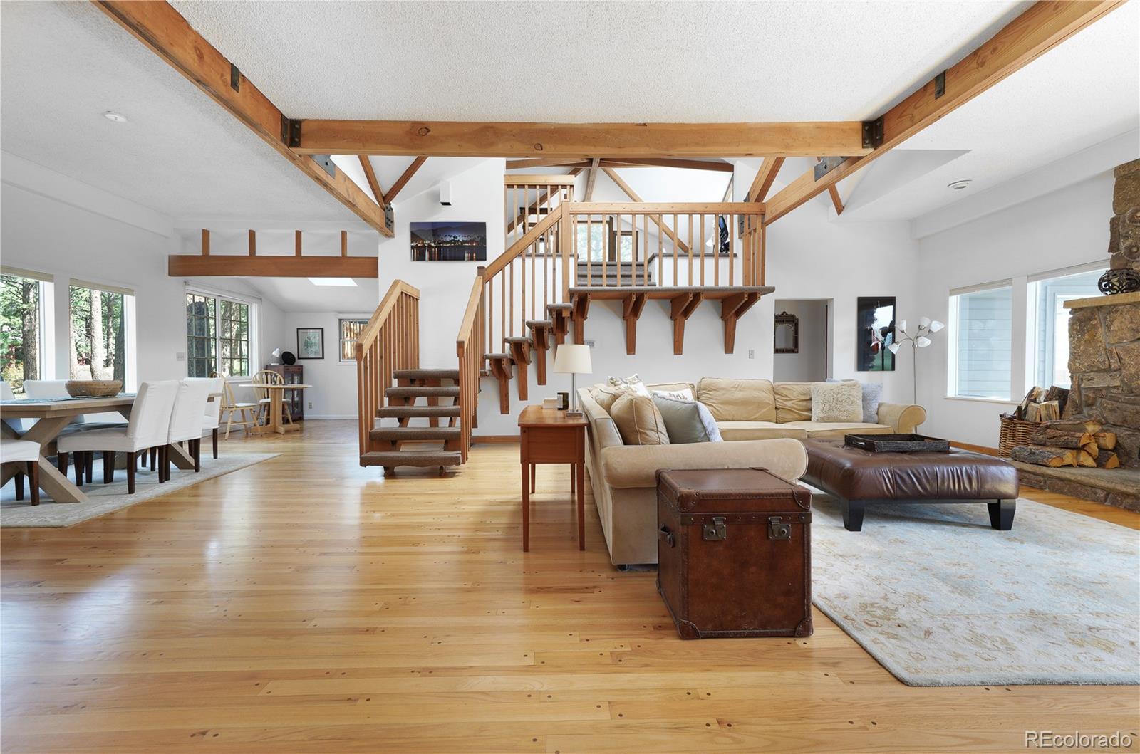 a living room with fireplace furniture and a wooden floor