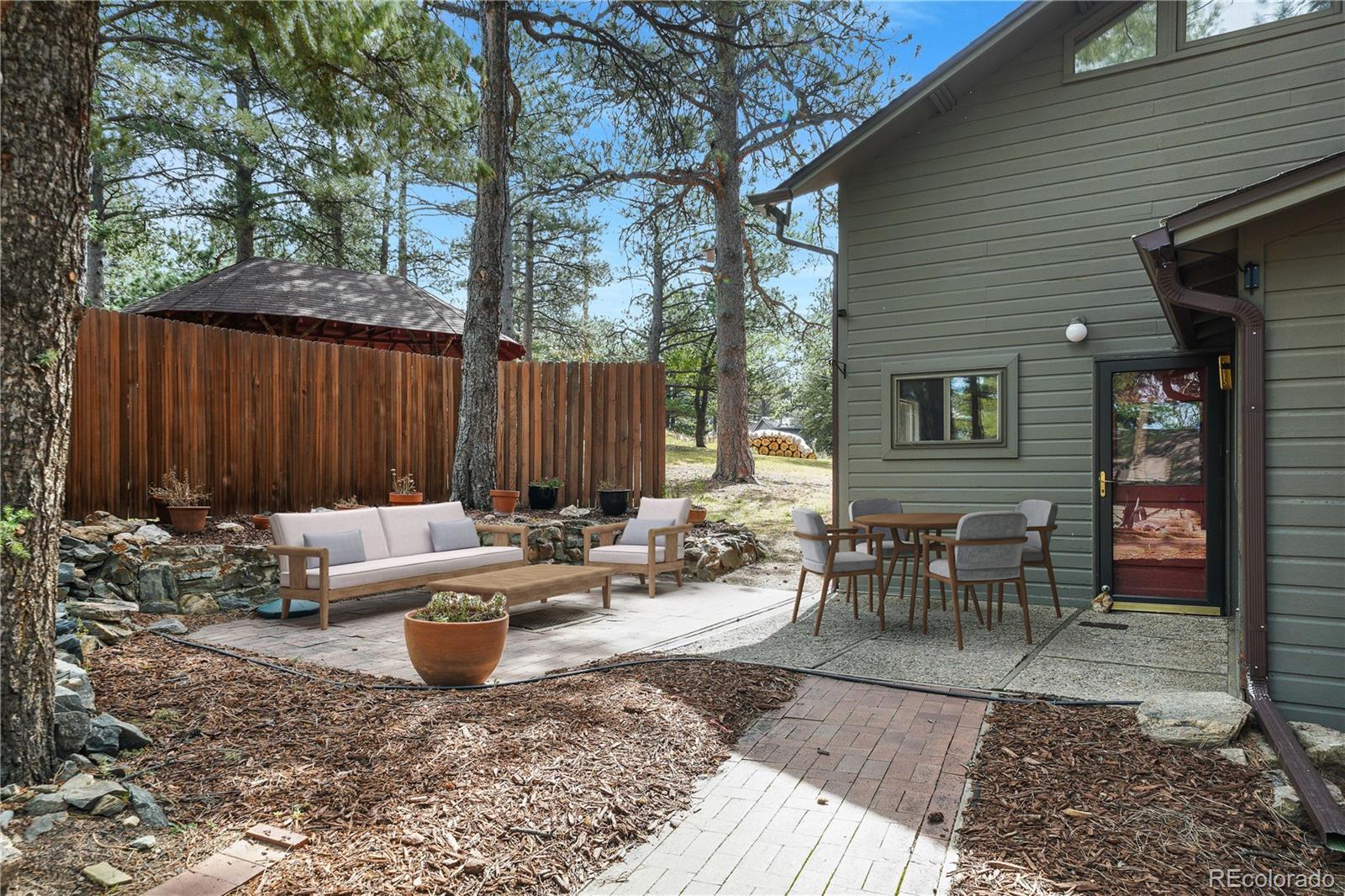 25997 Mountain View Road Golden, CO 80401 - Photo 12 of 23 a view of a backyard with sitting area