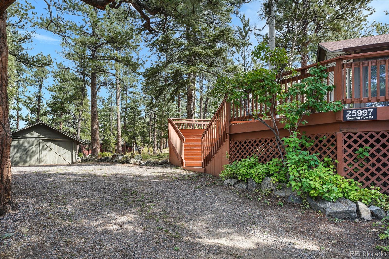 25997 Mountain View Road Golden, CO 80401 - Photo 14 of 23 a backyard of a house with lots of green space