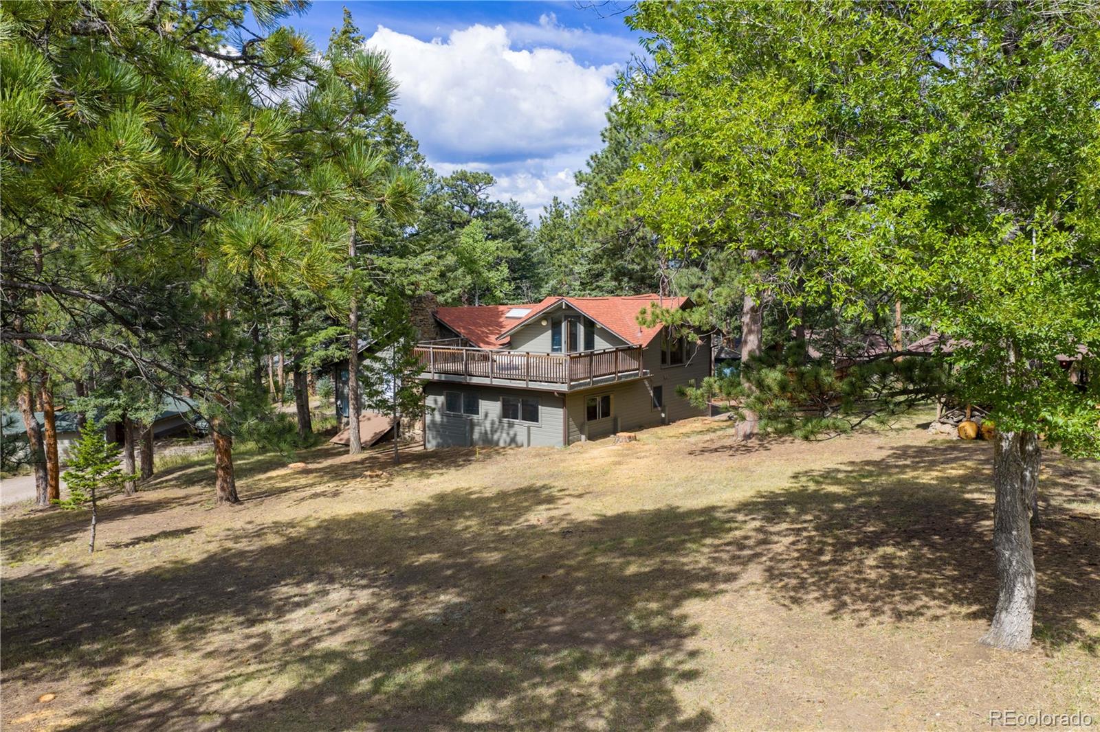 25997 Mountain View Road Golden, CO 80401 - Photo 17 of 23 a house with trees in front of it