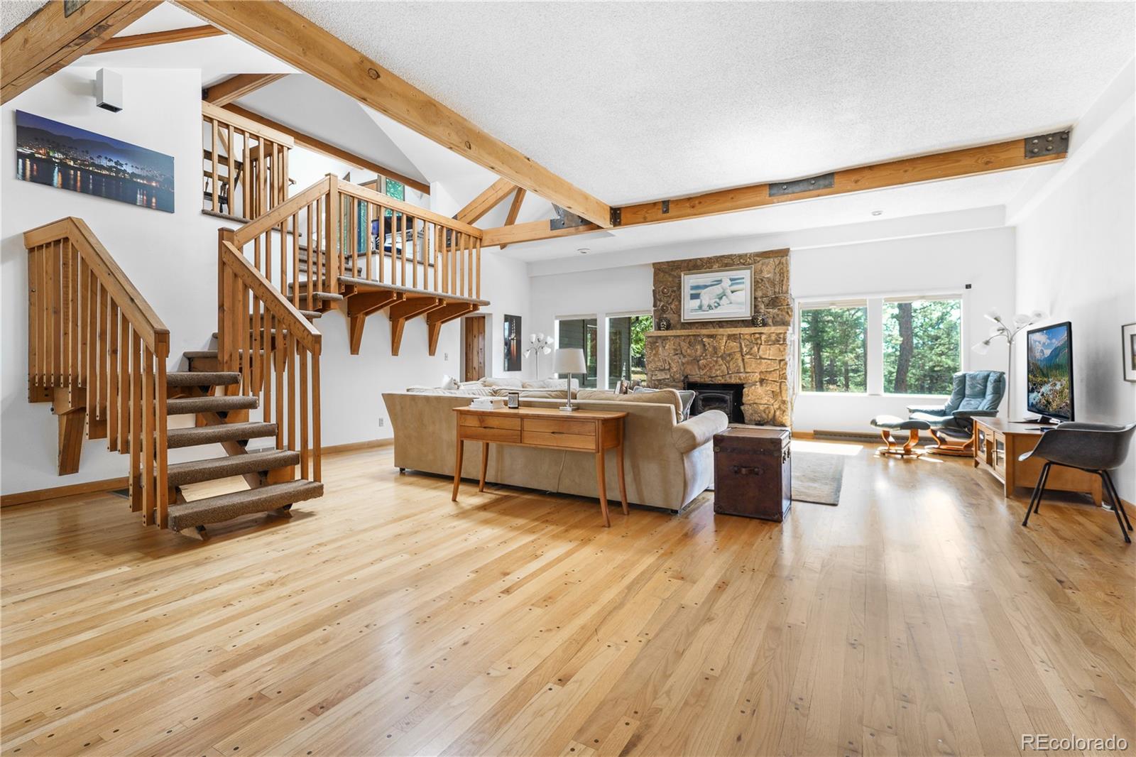 25997 Mountain View Road Golden, CO 80401 - Photo 2 of 23 a living room with furniture and a wooden floor