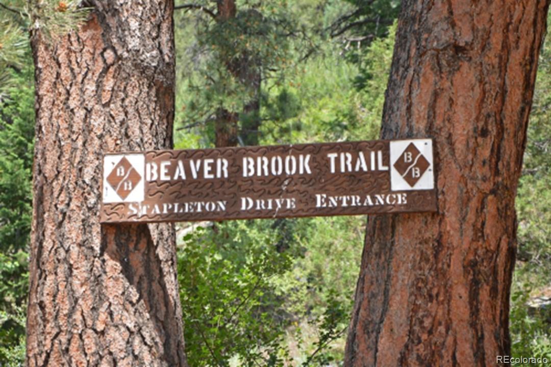 25997 Mountain View Road Golden, CO 80401 - Photo 21 of 23 a street sign that is sitting on a wooden wall