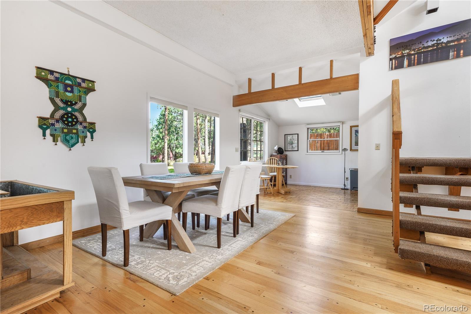 25997 Mountain View Road Golden, CO 80401 - Photo 3 of 23 a view of a dining room with furniture and wooden floor