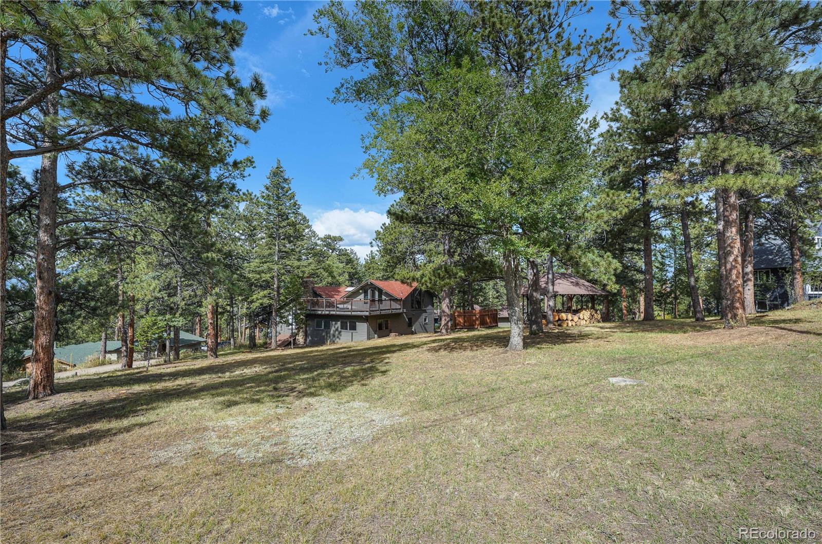 25997 Mountain View Road Golden, CO 80401 - Photo 8 of 23 a house with trees in front of it