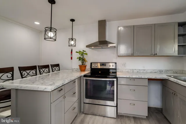 a kitchen with stainless steel appliances granite countertop a sink a stove and cabinets