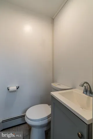 a bathroom with a sink toilet and a mirror