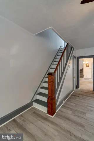 a view of entryway and hall with wooden floor