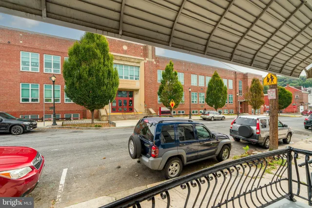 a view of a cars park in front of a building