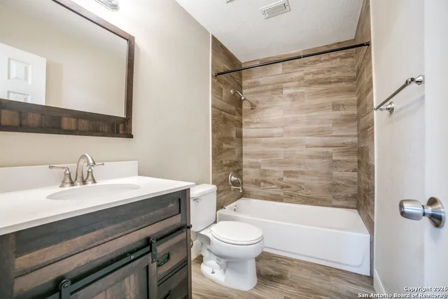 a bathroom with a sink a toilet and a bathtub