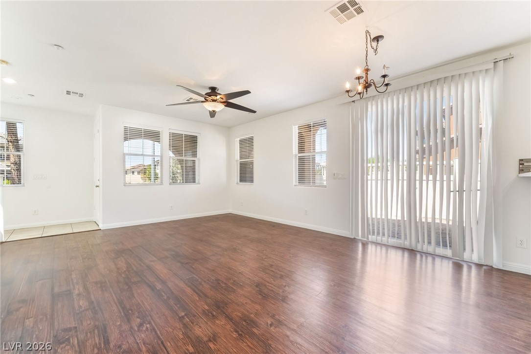 3175 Via Seranova Henderson, NV 89044 - Photo 12 of 45 Bright and airy living area featuring rich hardwood flooring and abundant natural light.